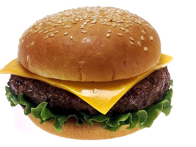 Illustrative photo of a cheeseburger with lettuce and tomato