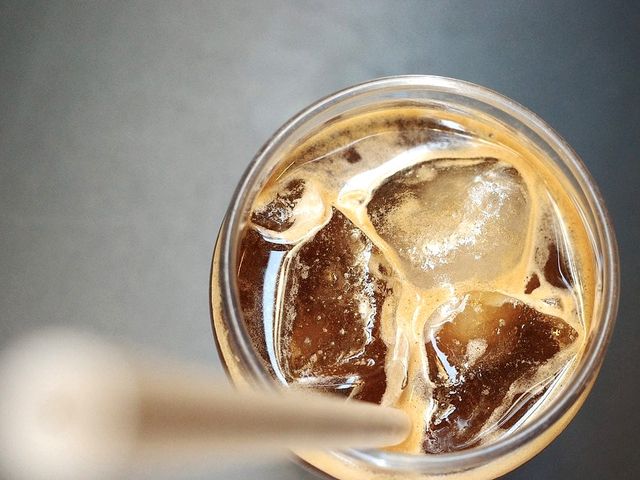 Illustrative photo of an iced coffee with a straw