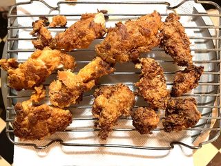 Photo: Fried chicken strips sitting on baking rack